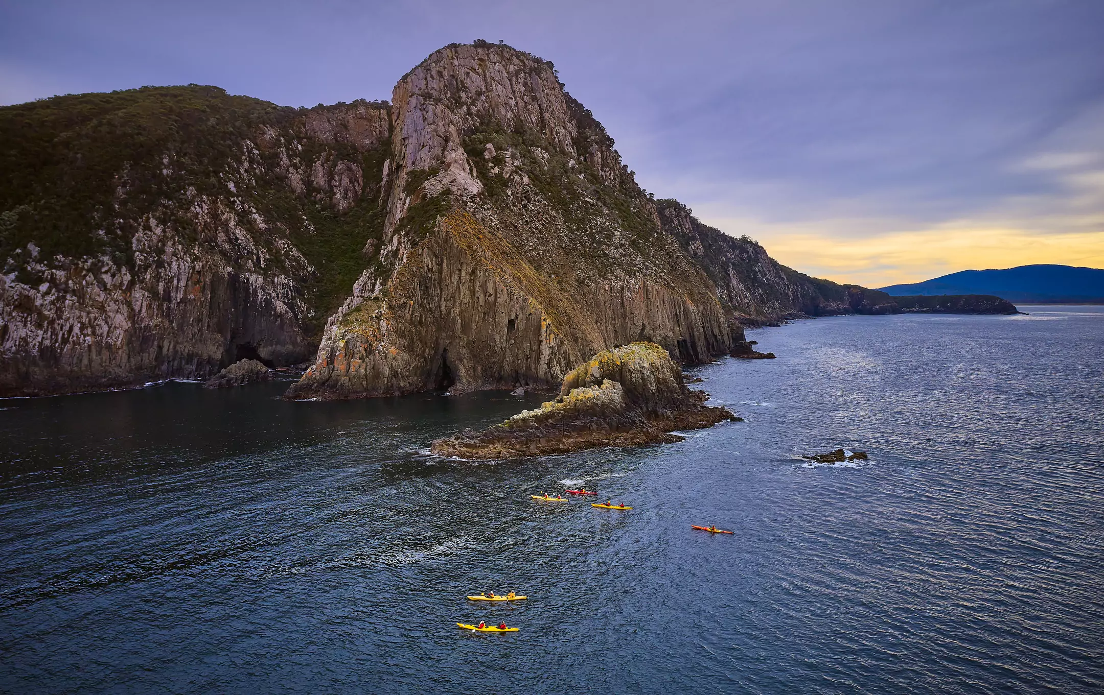 kayakers near beautiful coast